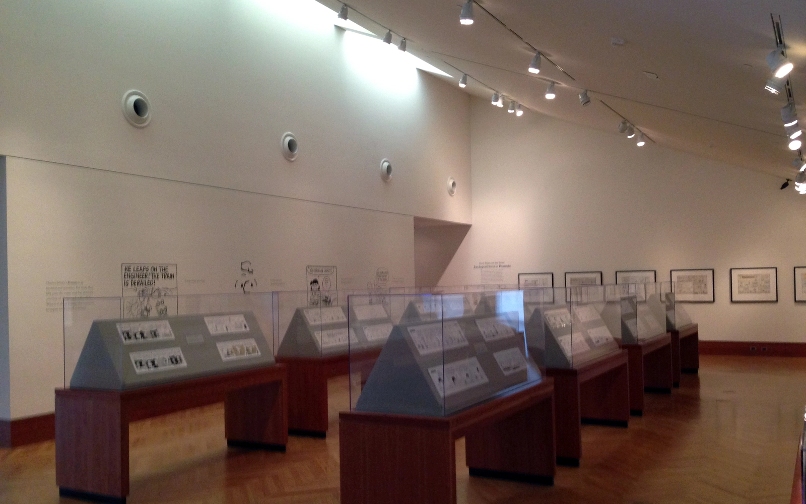 Display cases of original comic art at the Schulz Museum